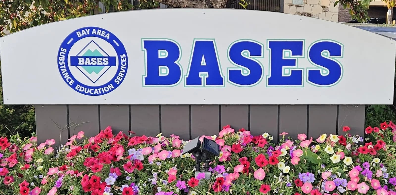 BASES road side sign with flowers.